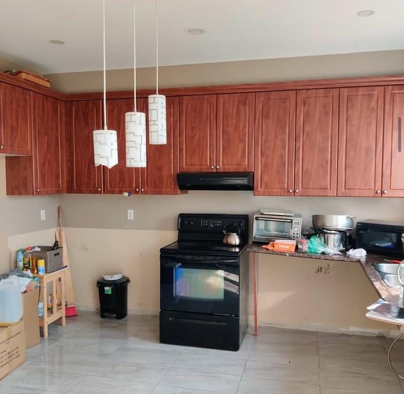 Kitchen before renovation with dated wood cabinets