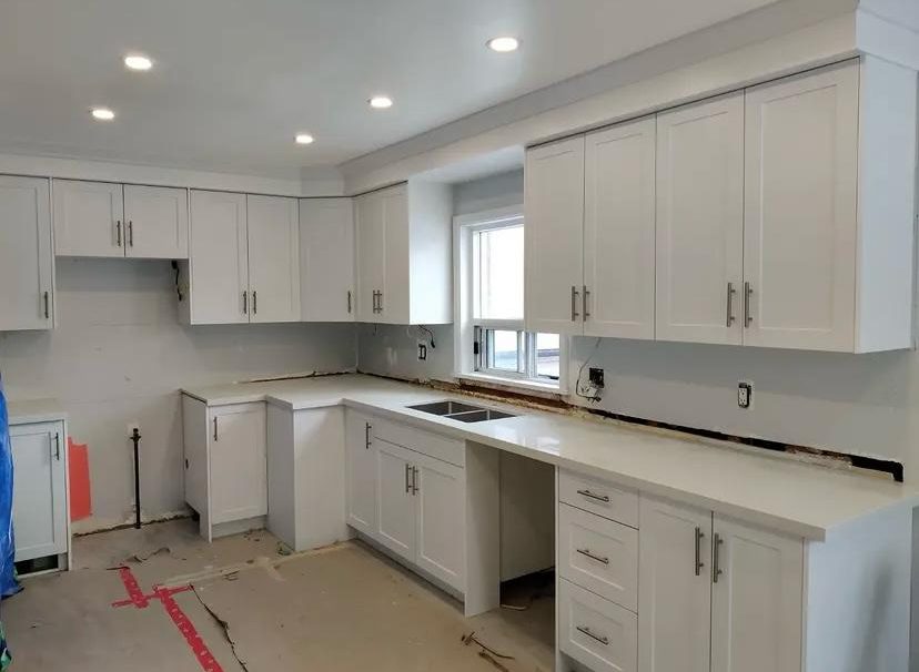 White shaker cabinets with quartz countertop during installation