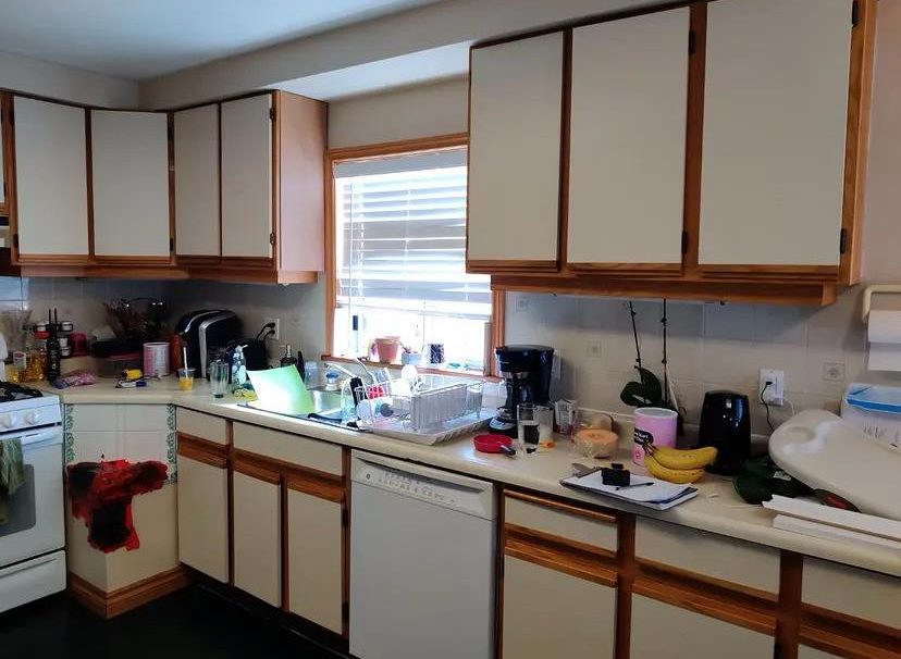 Kitchen before renovation with old two tone cabinets